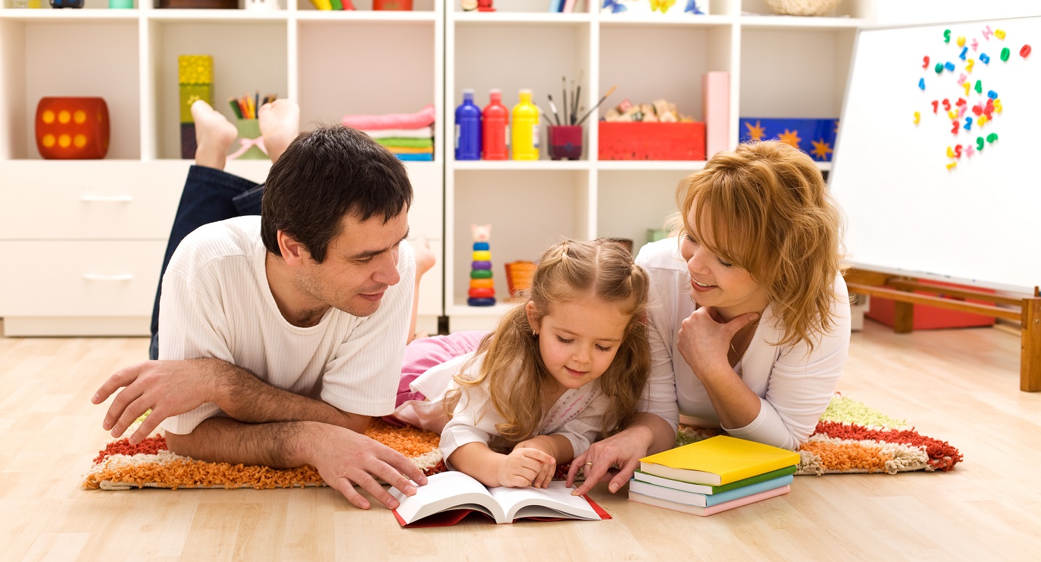Happy family reading in the kids room